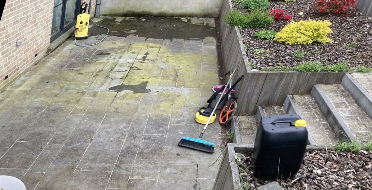 Black slabs before cleaning, covered in green moss